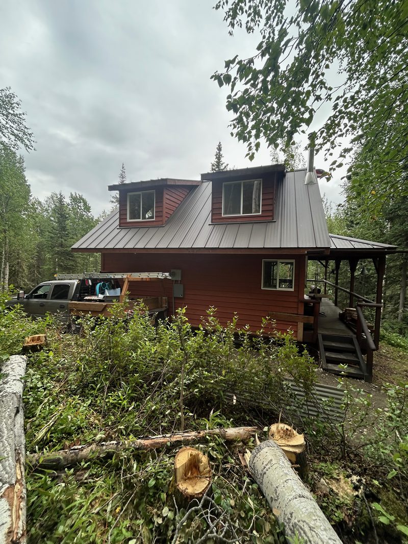 Red-stained cabin with metal roof